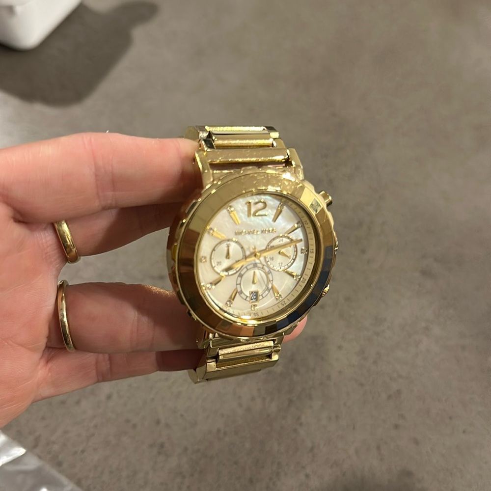 Michael Kors, gold watch mother of pearl face, needs battery, has extra links